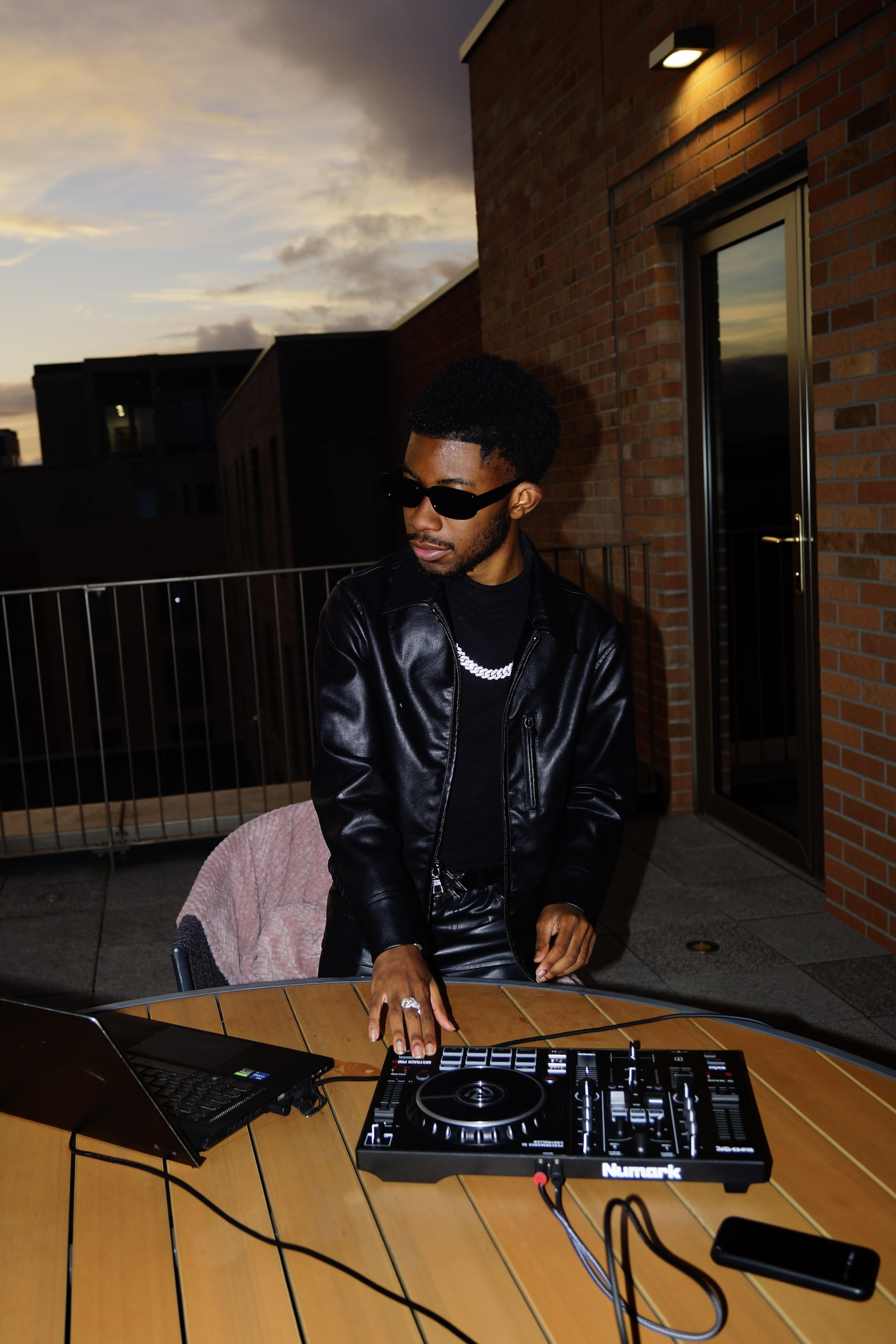varyence DJing outdoors at dusk